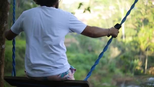 Slow Motion Shot Male Caucasian Tourist Swinging Swing Rice Paddies — Stock Video