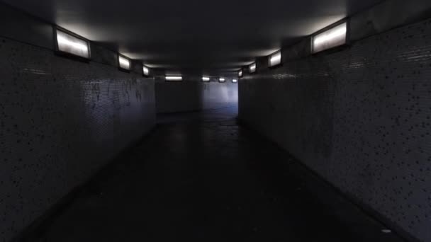 Handheld Footage Person Walking Scared Dim Lit Underpass Light End — Stock Video