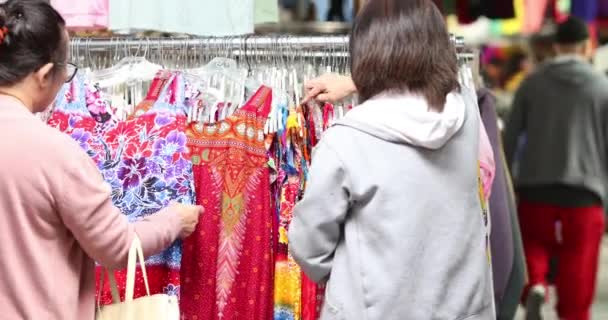 Two Women Looking Rack Colorful Clothes Outdoor Market Garage Sale — Stock Video