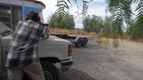 Slow Motion Caucasian Man Shoots Caliber Rifle While Leaning Hood — Stock Video