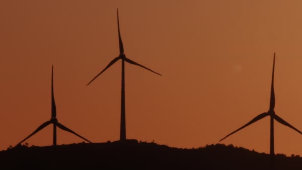 Three Wind Turbines Spinning Sunrise Silhouette Shot — Stock Video