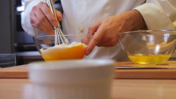 料理人は卵と砂糖をボウルに入れて混ぜ — ストック動画