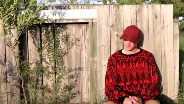 Male Adult Fence Wind Looking Sunny Wearing Black Red Sweater — Stock Video