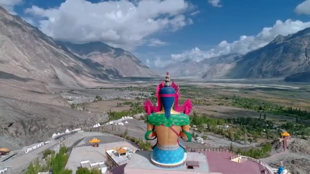 Drone Orbiting Tall Lord Budha Statue Facing Mountain Valley — Stock Video