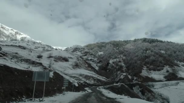 Muddy Mountainside Road Driving Snowcovered Trees Mountains — Stock Video