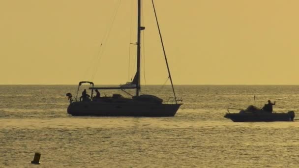 Small Motorboat Passes Sailing Yacht Calm Sea Dawn Slow Motion — Stock Video