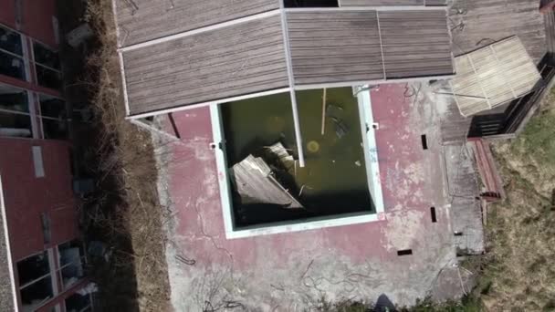 Top Aerial Drone Footage Rising Turning Abandoned Covered Pool Hotel — Stock Video