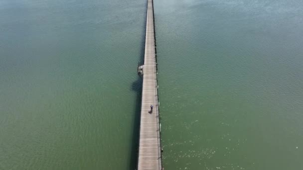 Overhead Aerial Shot Biker Riding Long Wooden Pier — Stock Video