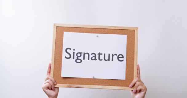 Woman Hand Shows Paper Board Word Signature White Studio Background — Vídeos de Stock
