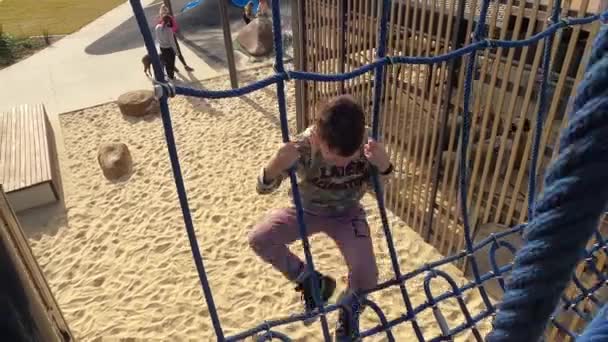 Cheeky Little Boy Hangs Blue Rope Swing Bridge Pretends Die — Stock Video