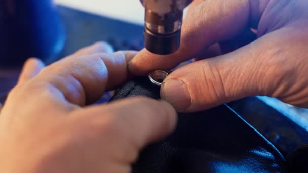 在服装厂的专用机的帮助下 皮革工手将金属圆锥钉在衣服上的闭合视图 手动冲压压力机 — 图库视频影像