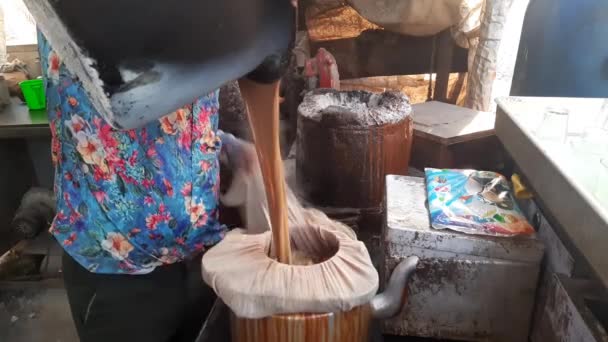 Tea Seller Straining Tea Cloth Pouring Kettle — Stock Video