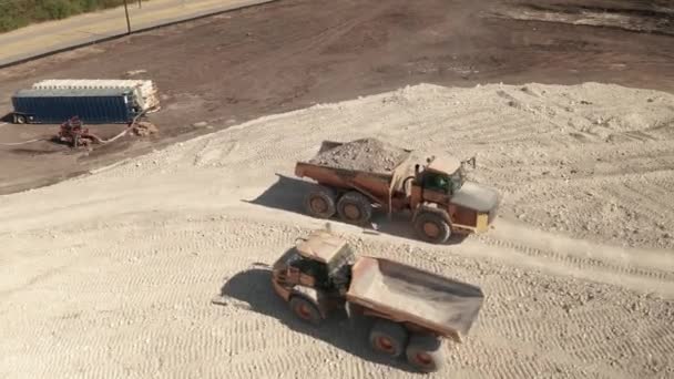 Empty Dump Truck Passes Full Dump Truck Construction Site — Stock Video