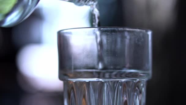 Close Pouring Water Glass Jug Blurry Bokeh Background Slow Motion — Stock Video