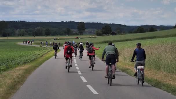 Rear View Pov Crowd Cyclist Riding Bike Asphalt Road Switzerland — Stock Video