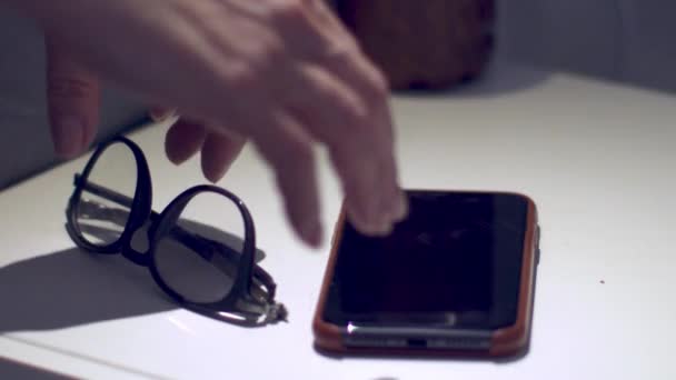 Tangan Orang Tak Dikenal Meraih Telepon Dan Gelas Dari Meja — Stok Video