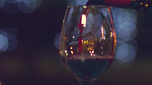 Pouring Red Wine Wineglass Bottle Slow Motion Background Blurred Bokeh — Stock Video