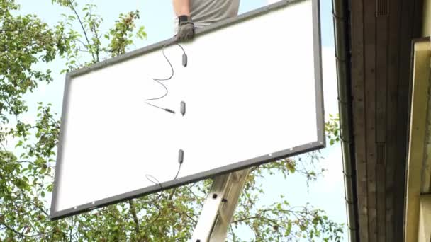 Werknemer Klimmen Ladders Houden Enorme Zonnepaneel Handheld Uitzicht — Stockvideo