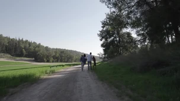 Drone Tracking Family Small Child Walks Dog Open Field Back — Stock Video