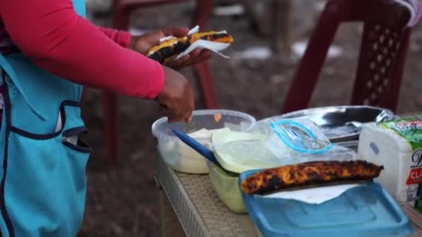在Galapagos的San Cristobel为顾客准备烤香蕉街食品的女卖主 — 图库视频影像