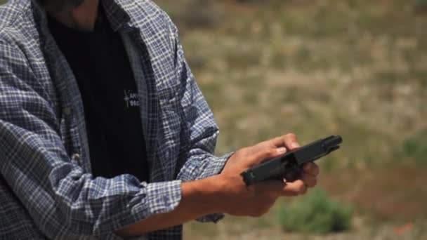 Caucasian Man Checking Jammed Glock Gun Outdoor Practice Range — Stock Video