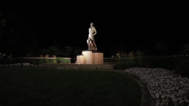 位于密歇根东兰辛市密歇根州立大学校园里的斯巴达雕像 夜间慢镜头带着金宝视频向前走着 — 图库视频影像