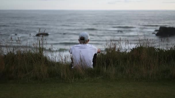 Young Man Pondering Deep Thought Overlooking Oregon Coast Sunset — Stock Video