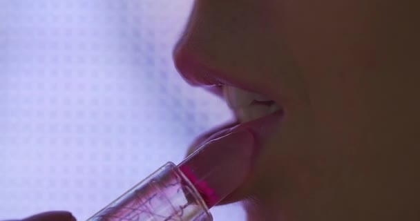 Young Woman Applies Lipgloss Her Lips While Moving Led Screen — Stock Video