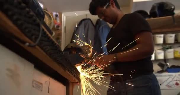 Asian Teenager Working Garage Shaping Metal Bench Grinder Igniting Sparks — Stock Video