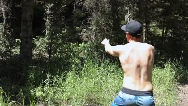 Slow Motion Shot Shirtless Man Practicing His Axe Throwing Skill — Stock Video