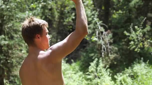 Slow Motion Shot Shirtless Man Practicing His Axe Throwing Skill — Stock Video