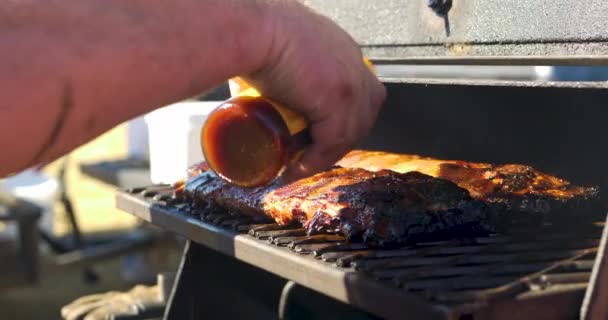 Man Pouring Bbq Sauce Rack Ribs Placing Them Smoker — Stock Video