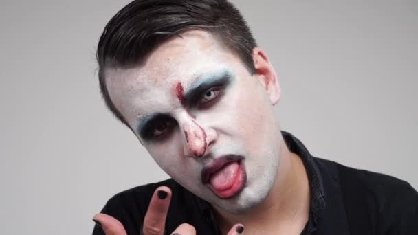 Face Painted Man Showing Tongue Devil Horns Fingers Closeup Portrait — Stock Video