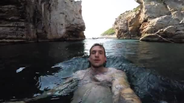 Jeune Homme Souriant Alors Nage Dans Une Eau Chaude Limpide — Video