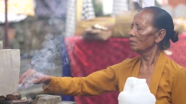 Old Woman Bali Tends Offerings Burning Incense Her Temple Elderly — Stock Video