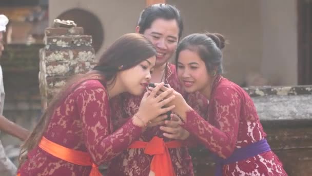 Drei Frauen Passenden Roten Spitzenkleidern Betrachten Ein Handybild Und Lachen — Stockvideo
