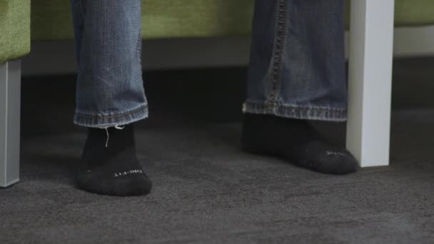 Close Man Feet Walks Frame Sits Couch Puts Pair Shoes — Stock Video