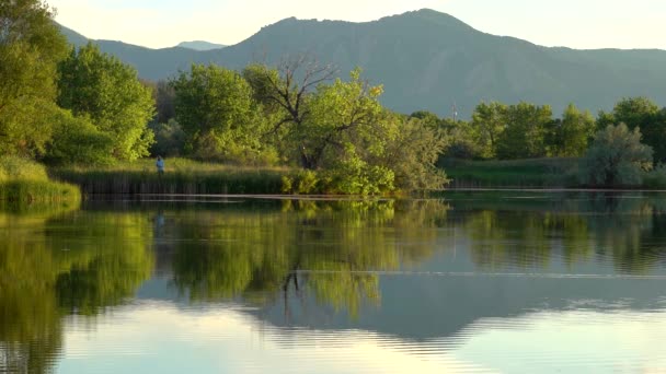 Man Fishing Lake Beautiful Mountain Views Reflection — Stock Video