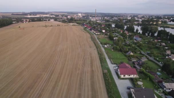 Flying Harvested Wheat Field Next Small Village — Stock Video