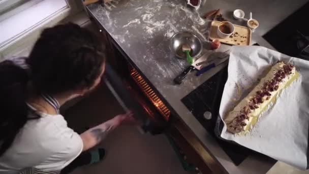 후식이나 파이를 오븐에 제빵사 소녀의 각도로 바라본 — 비디오