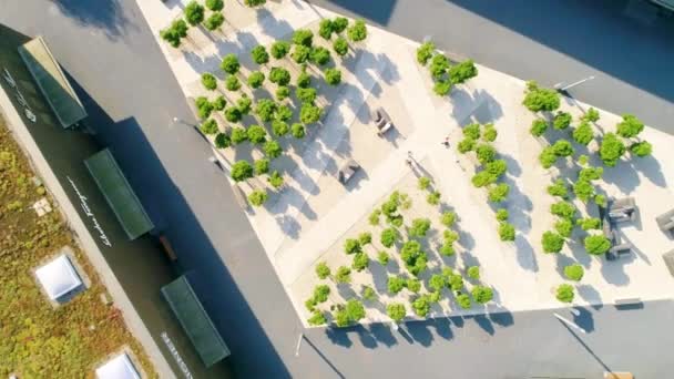 空中鸟瞰着一个有棱角的现代广场 绿色的小树 周围都是贪婪的屋顶的商店 — 图库视频影像
