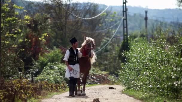Romanian Traditional Costume Walks Next Horse — Stock Video
