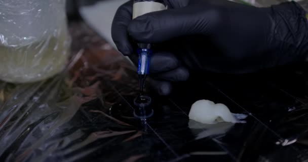 Tattoo Artist Getting Ready Sucking Black Ink Blue Needle Hand — Stock Video