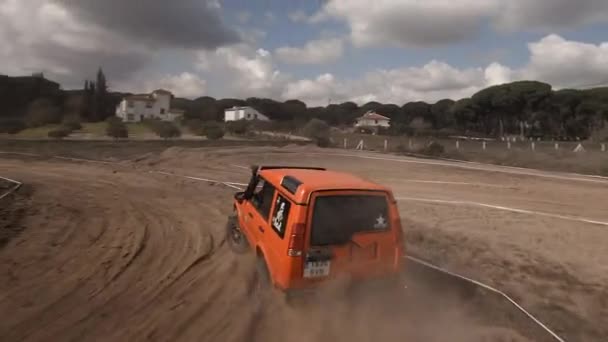 Fpv Drone Chases Bright Orange Land Rover Iberlince Road Race — Stock Video