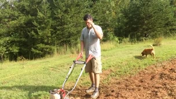 Young Man Tilling Garden Backyard — Stock Video