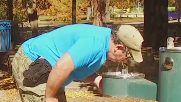 Homem Bebendo Fonte Bebendo Parque Belo Dia Ensolarado Cercado Por — Vídeo de Stock