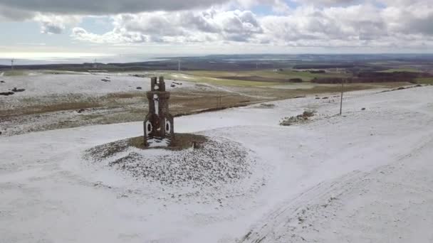 セントジョンズの空中映像スコットランドのアバディーンシャーで冬の日の雪の中のマウント記念碑 — ストック動画