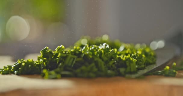 Close Shot Fresh Chopped Chives Laying Wooden Cutting Board Water — Stock Video