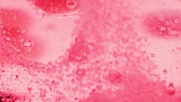 许多红色小泡泡在水中闪烁着的宏观镜头 一个大泡泡在明亮的背景下突然脱落而破碎 — 图库视频影像