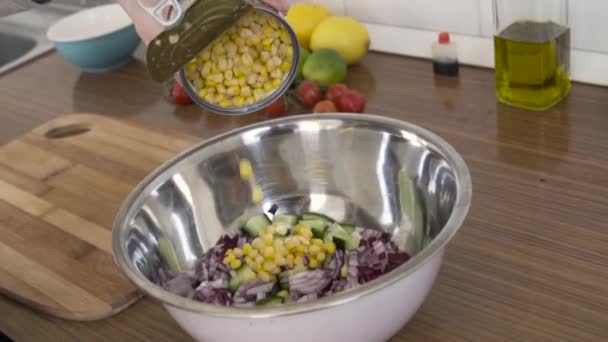 Making Salad Kitchen Adding Corn Bowl Full Vegetables — Stock Video